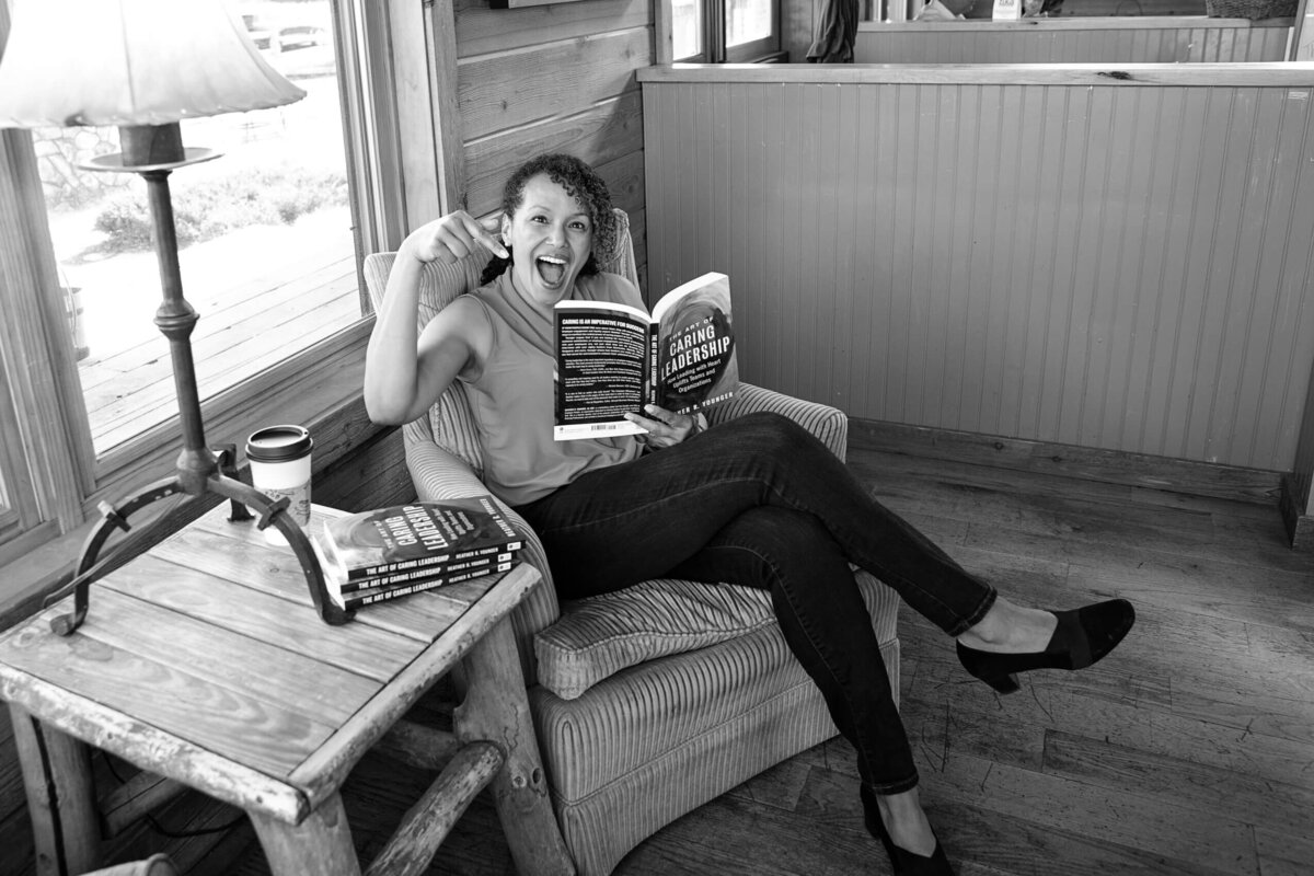 female-author-holding-book-sitting-smiling-branding-photography-denver-colorado