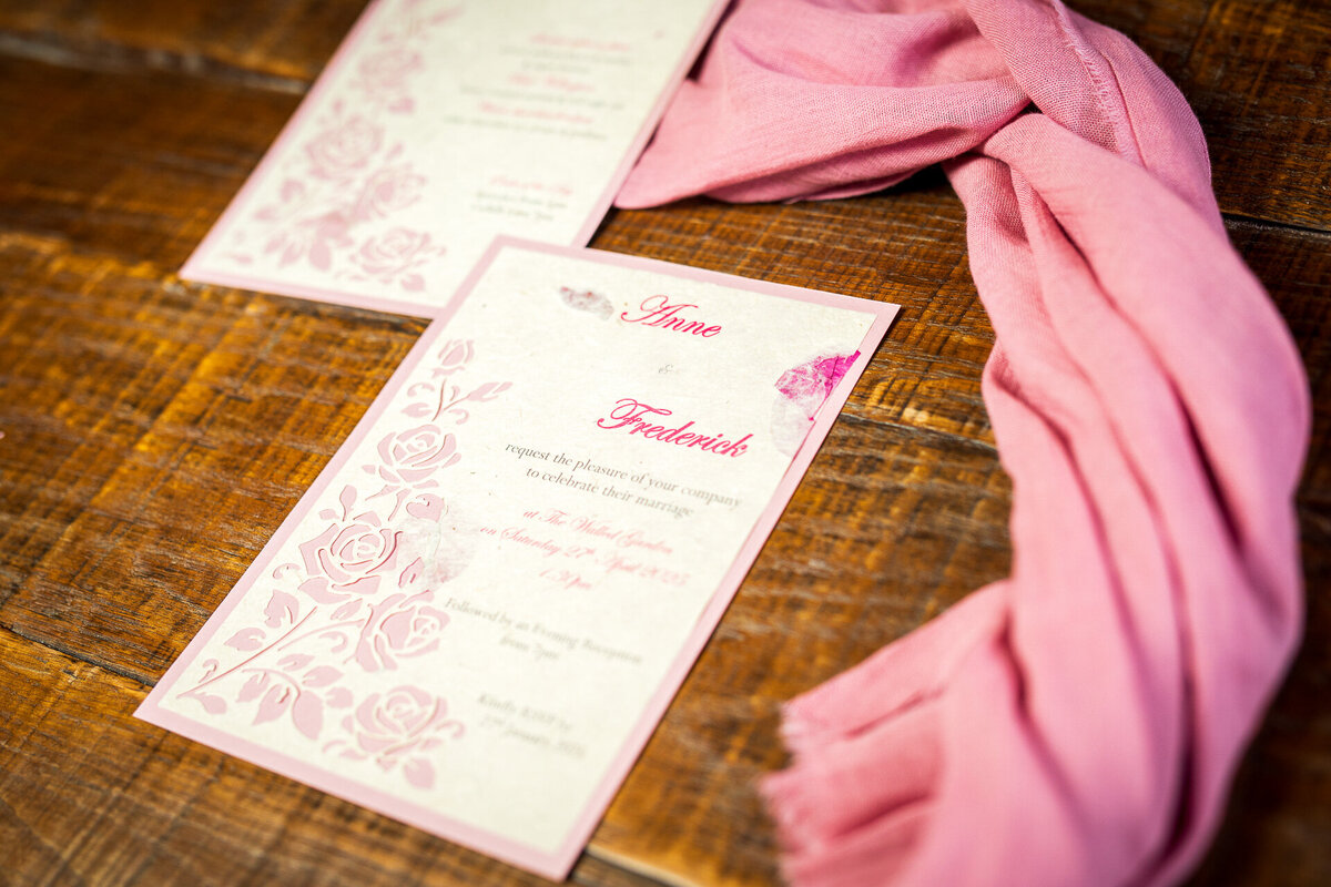 Wedding invitation on sustainable lokta paper with embedded rose petals