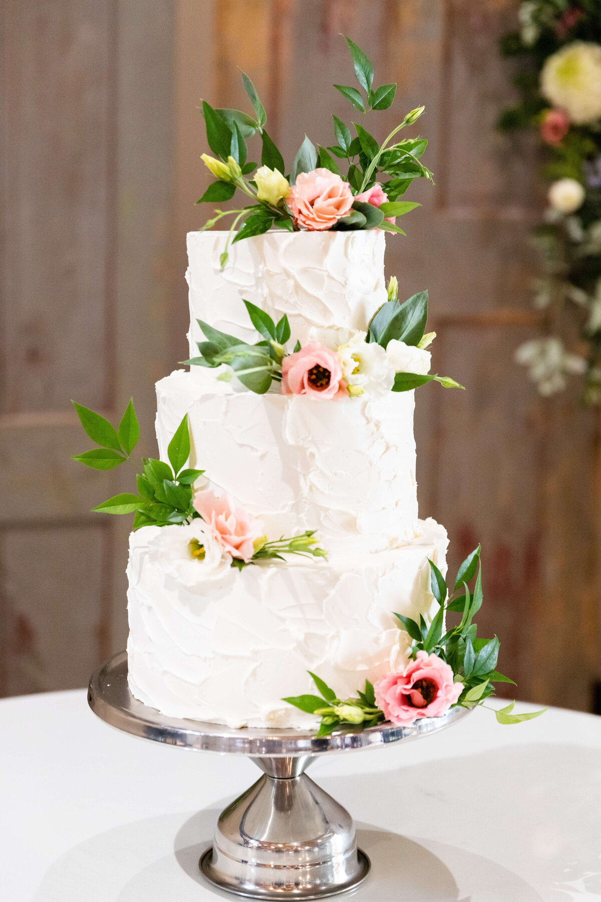 3 tiered wedding cake with floral accents