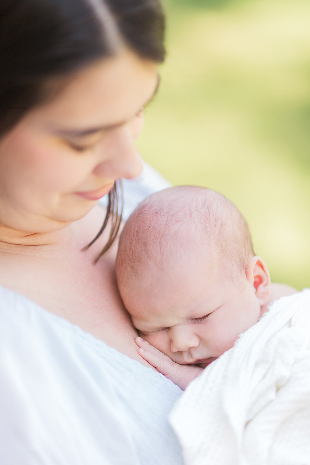 Mom and newborn in natural outside lighting during newborn photo session