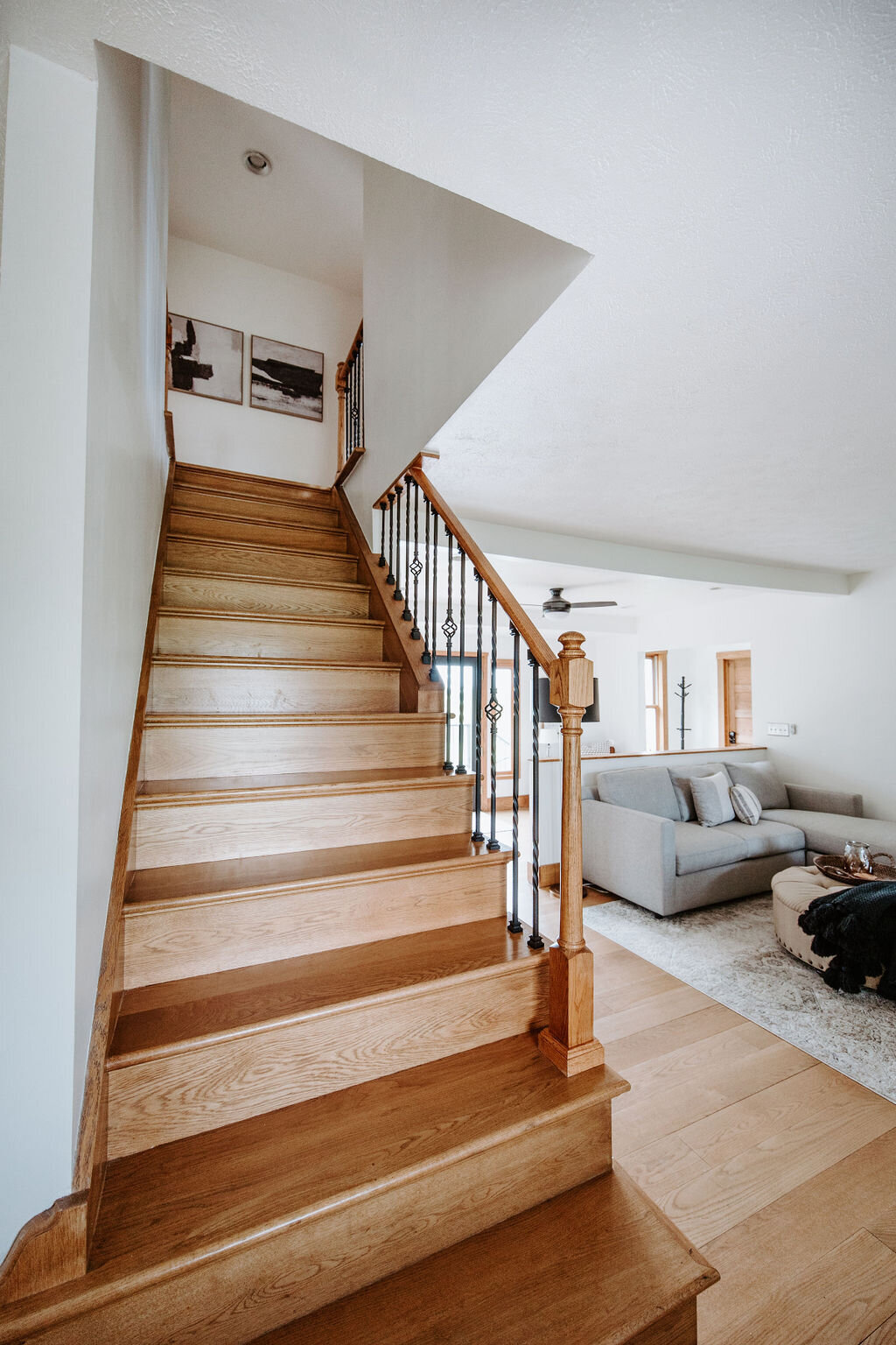 the oak wood staircase leading to the second floor bedrooms in the modern farmhouse overnight accommodations at the Willowbrook wedding venue