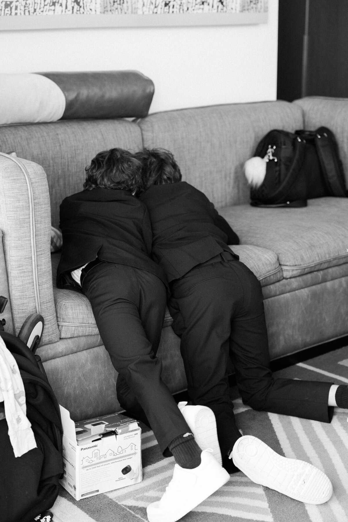 Two ring bearers lay on William Vale sofa