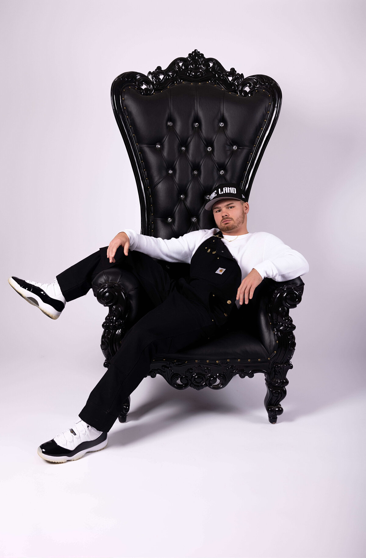 Professional boxer sitting in throne chair in birthday session with Reva Davis photography