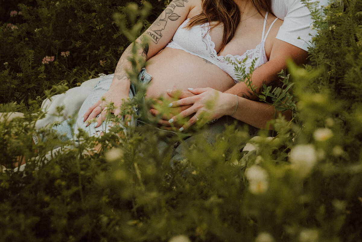 Explore whimsical maternity photos in a beautiful garden setting in Minnesota. Perfect for mothers-to-be who love nature and vibrant blooms