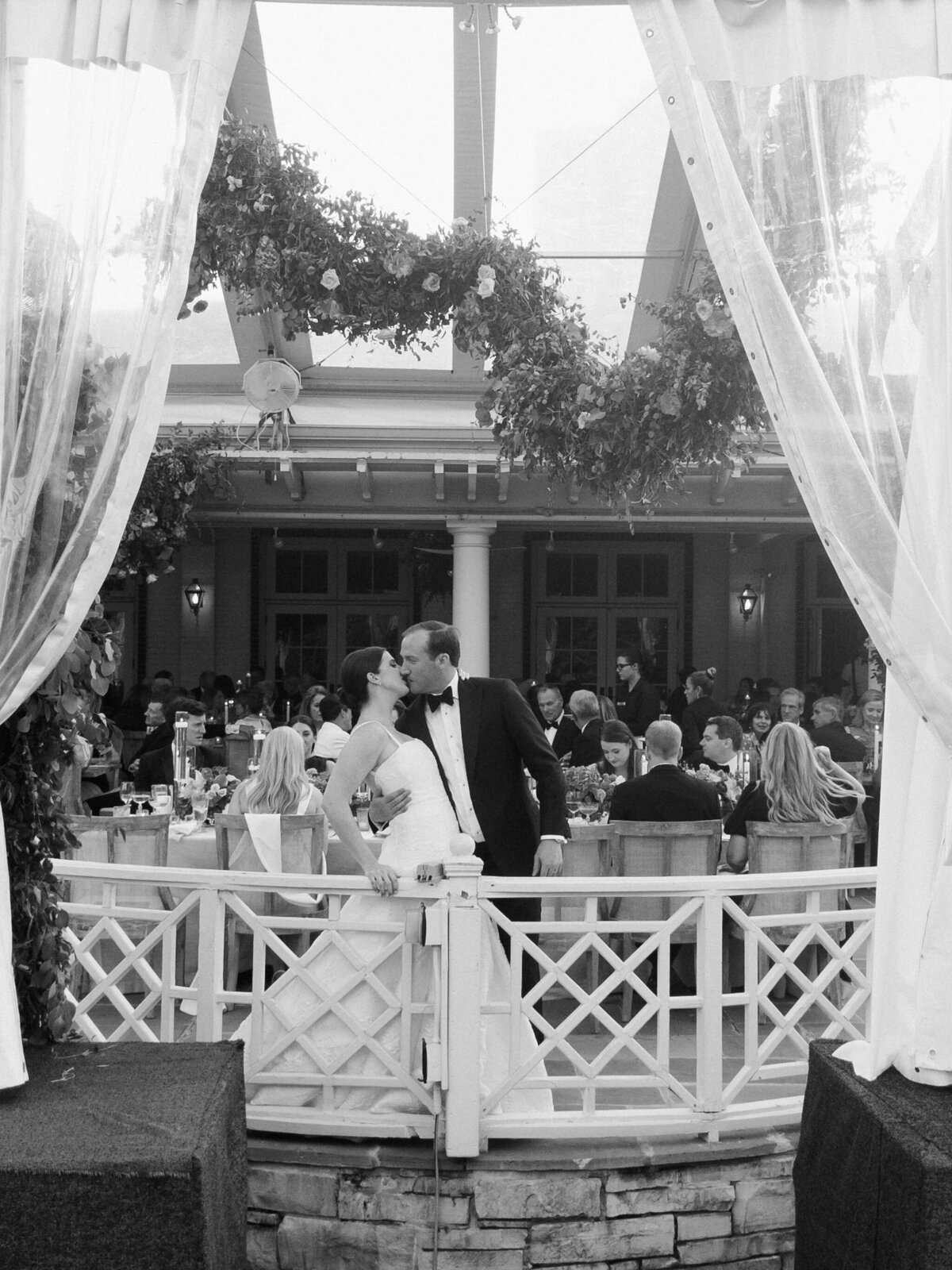 Black and white photo of the bride and groom sharing a dance. 