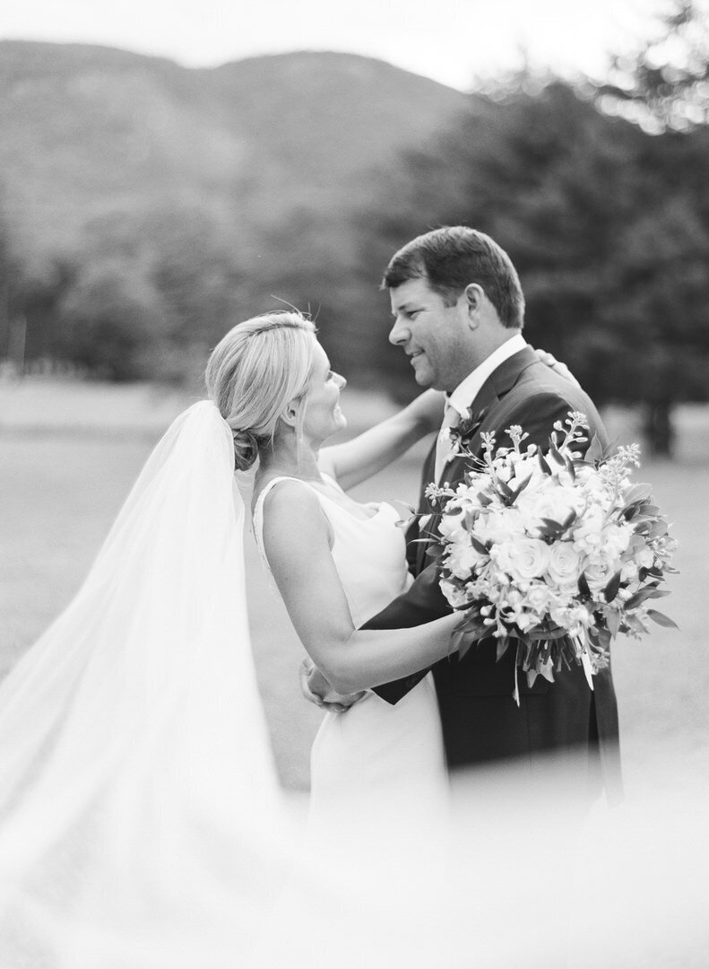 Black and White of Bride and Groom Smiling at Each Other Photo