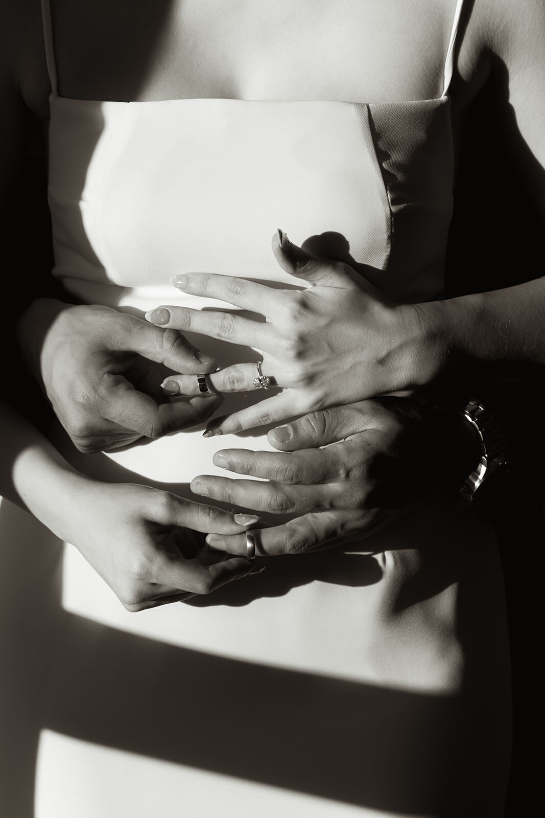 A close up of bride and grooms head with their rings in North Carolina.