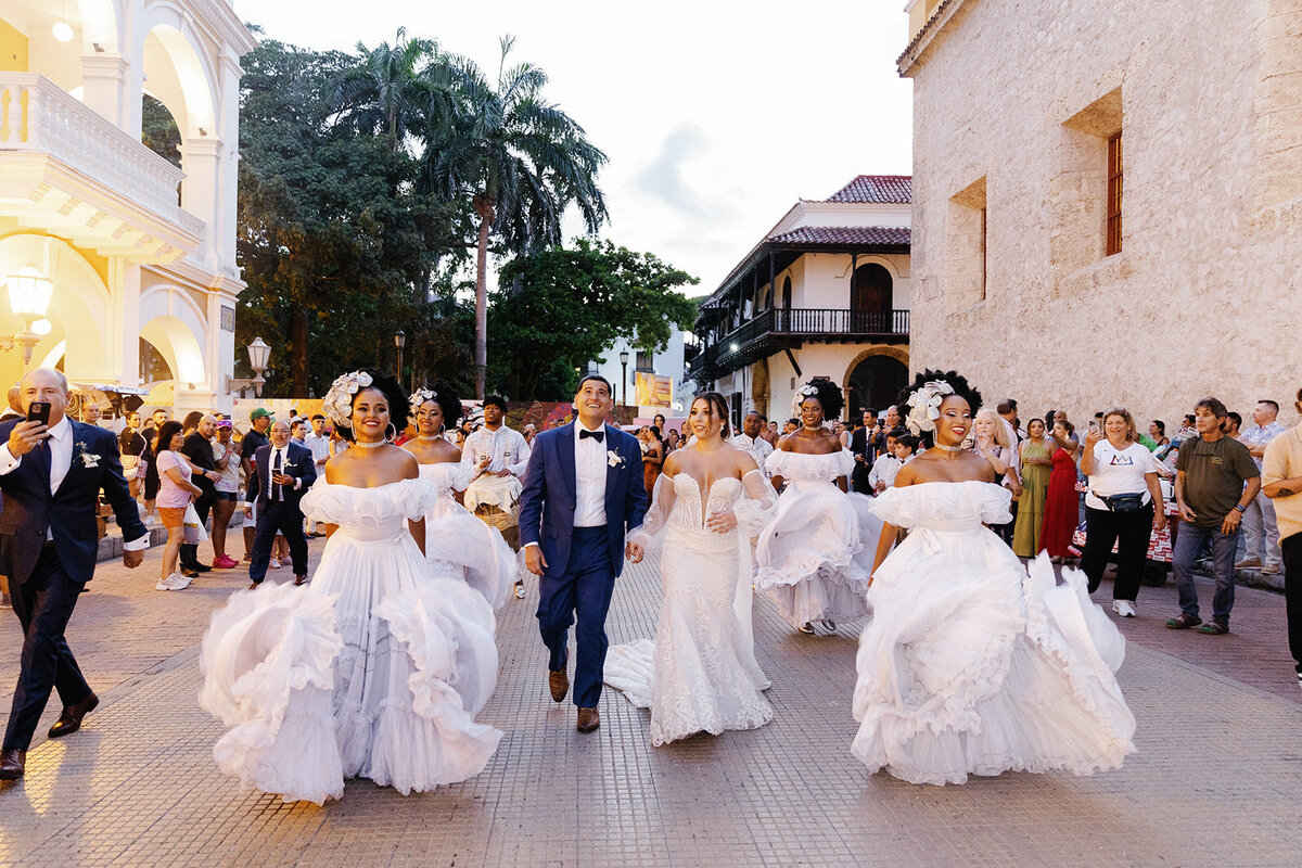 A joyful celebration as Victoria and Daniel dance with folkloric performers in the streets of Cartagena, Colombia.