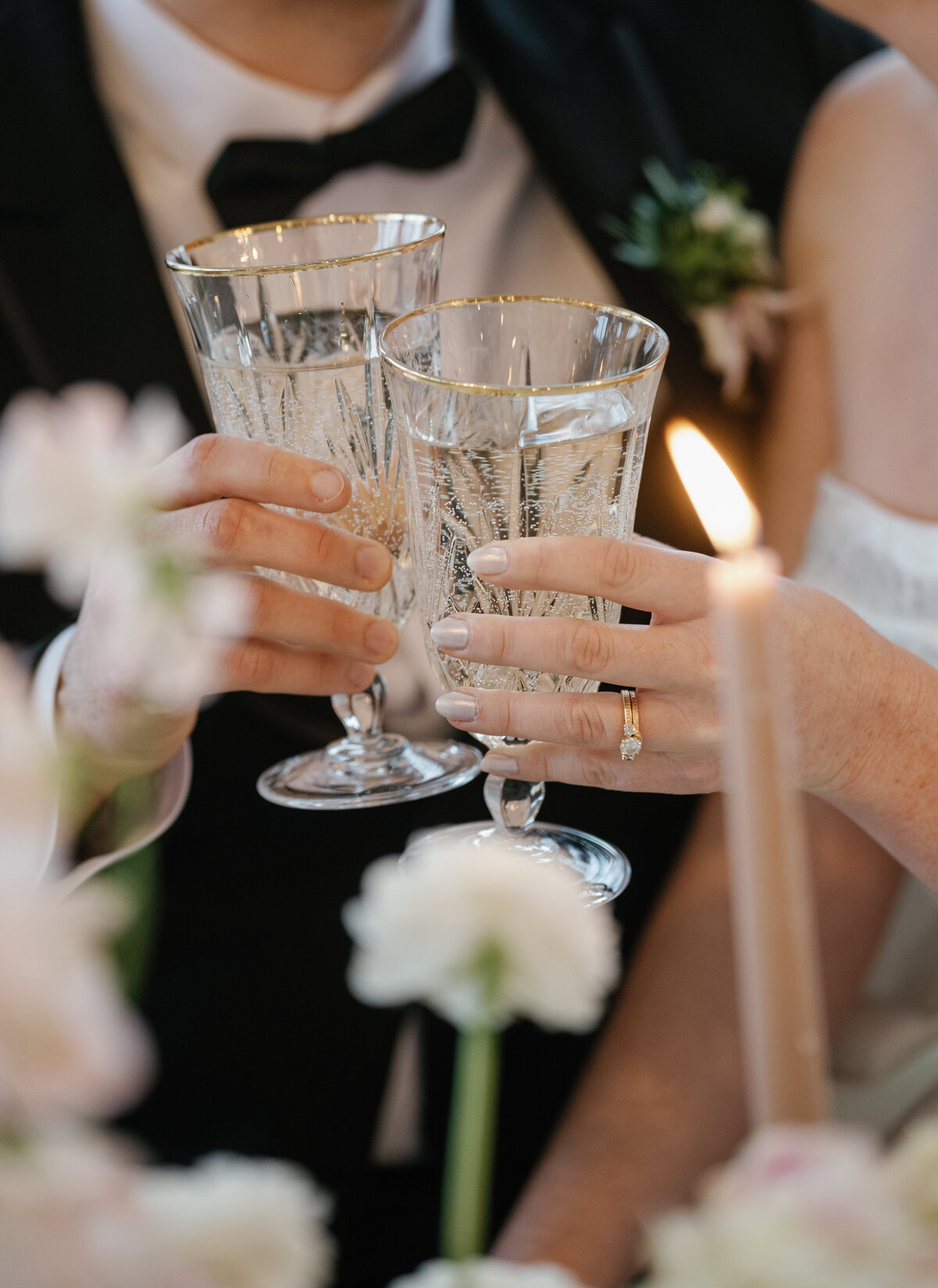 A bride and groom cheers with their champagne glasses 