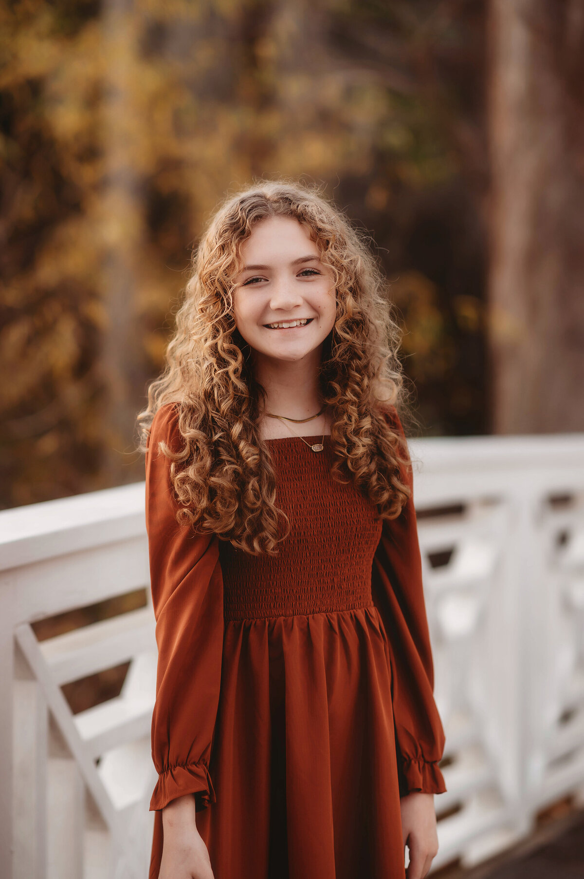 Little girl smiles at the camera during her Family Portraits at Cypress Gardens near Charleston, South Carolina.