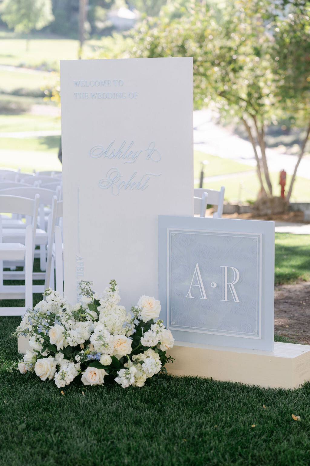 Welcome sign, ground arrangement, light blue signage, 