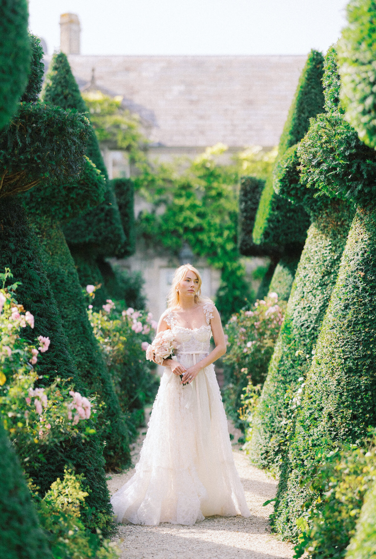 Brides stands in a fantastical garden