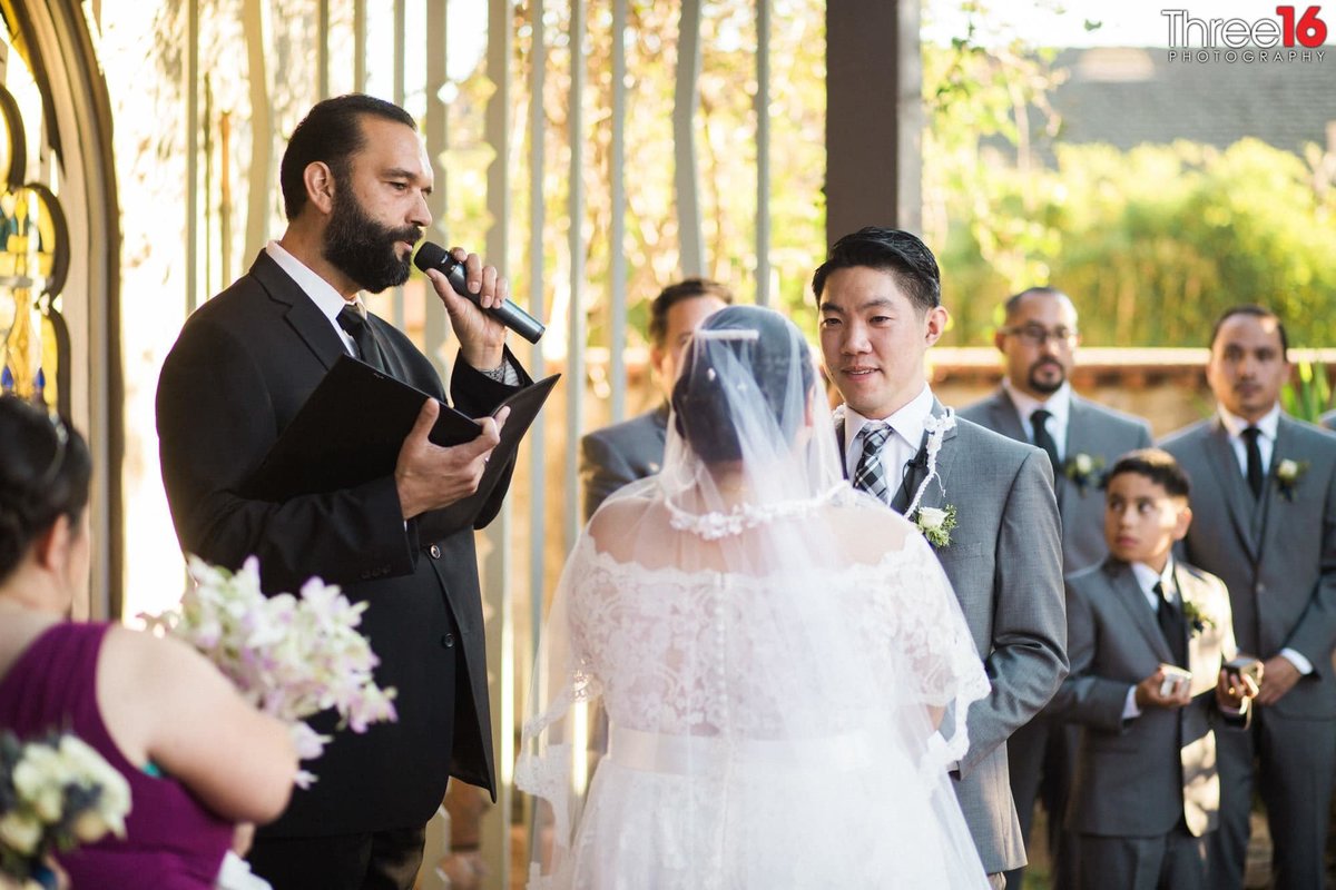 Officiant performing wedding ceremony while the couple look at each other