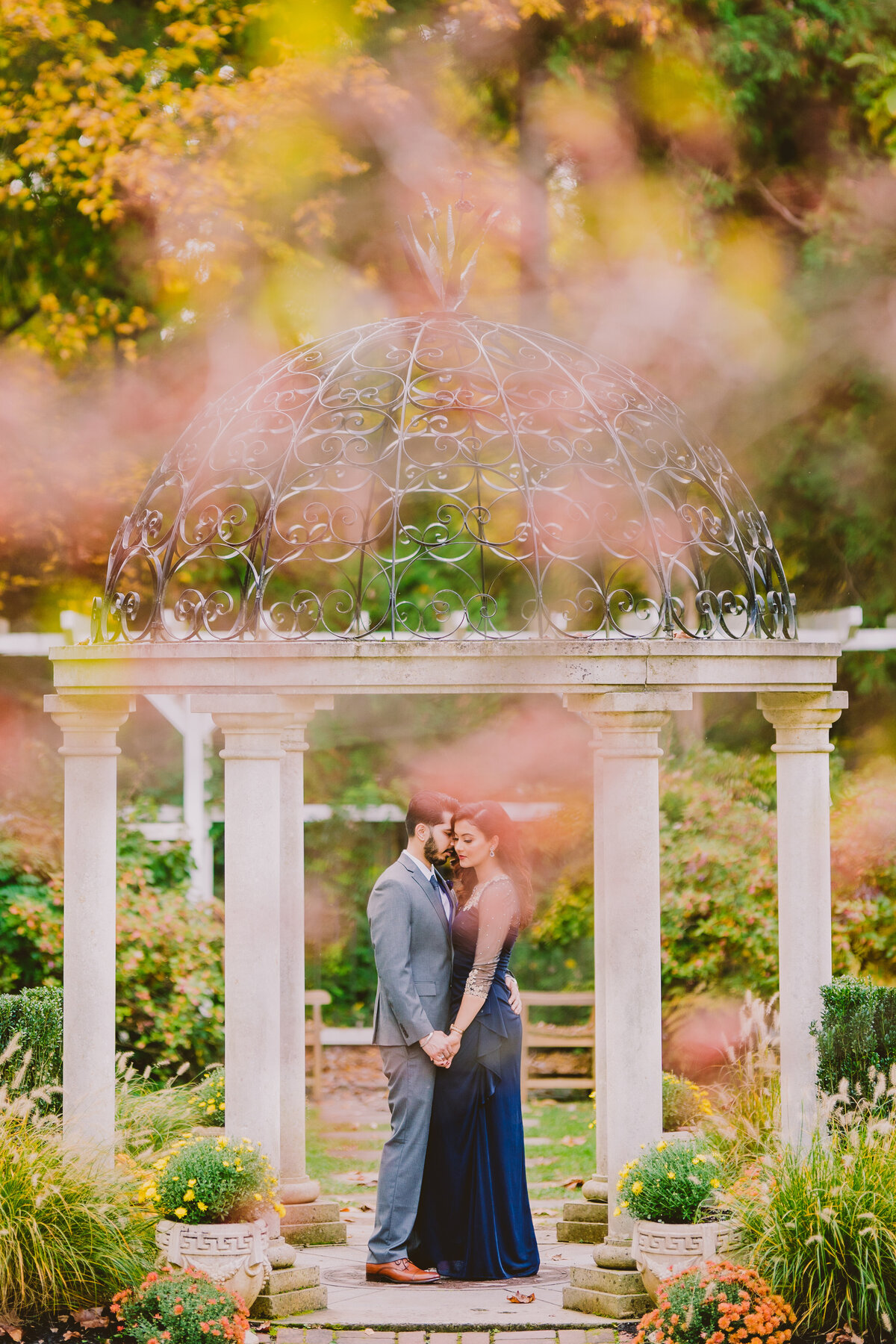 An engaged couple have a moment under the gazebo at sayen gardens in nj