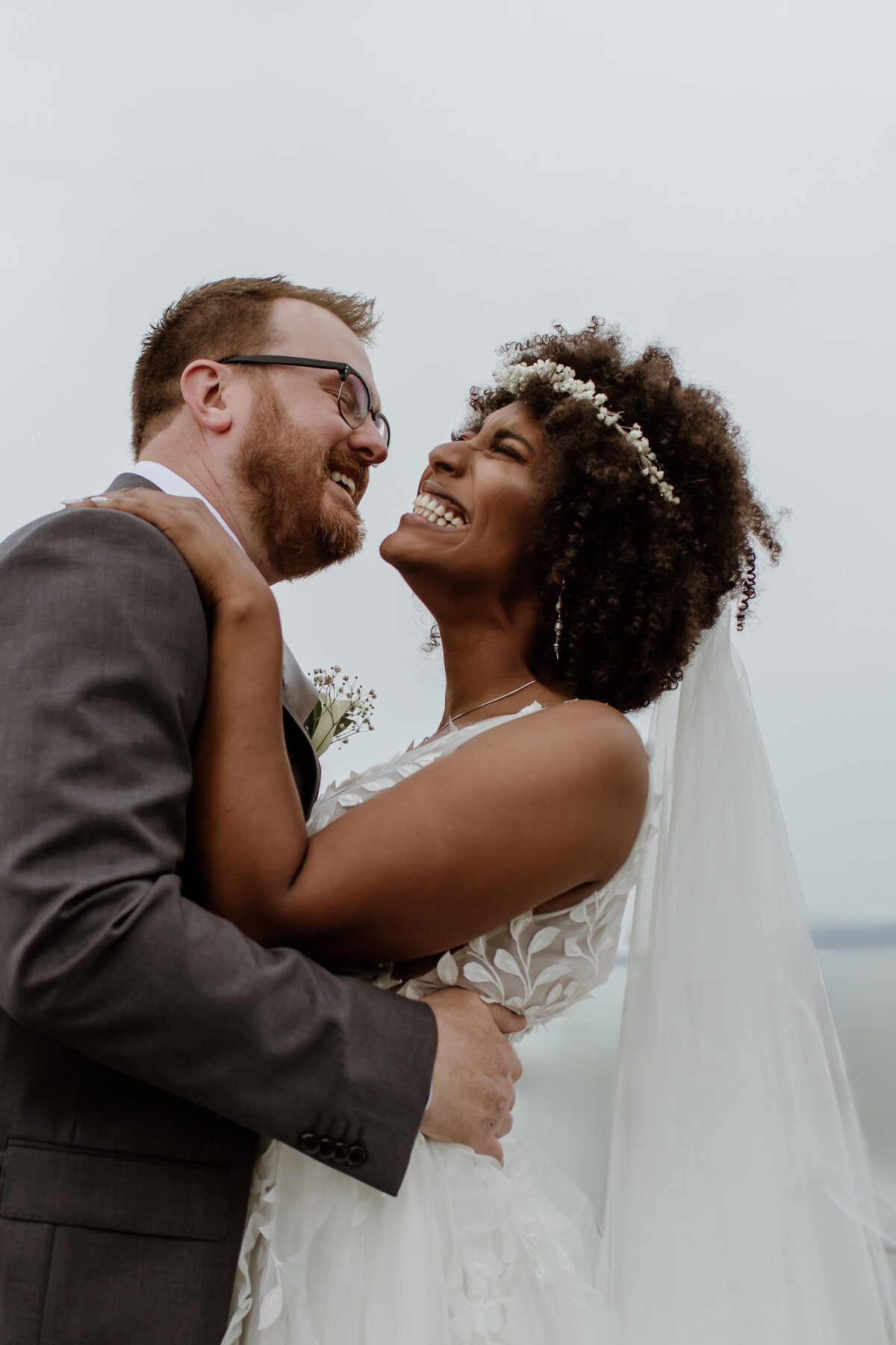 A cute candid of a bride and groom with big smiles. Captured by Fort Worth Wedding Photographer, Megan Christine Studio