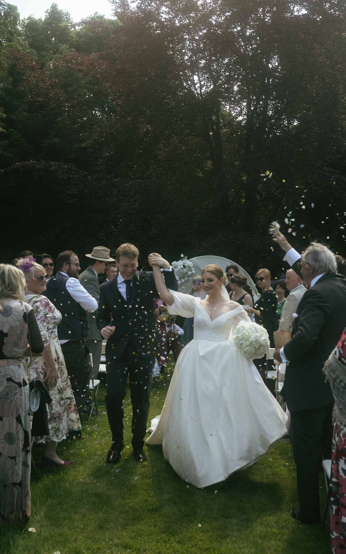 Joyful moment captured as a newly married couple celebrates with confetti, embodying love, happiness, and the start of their lifelong journey together