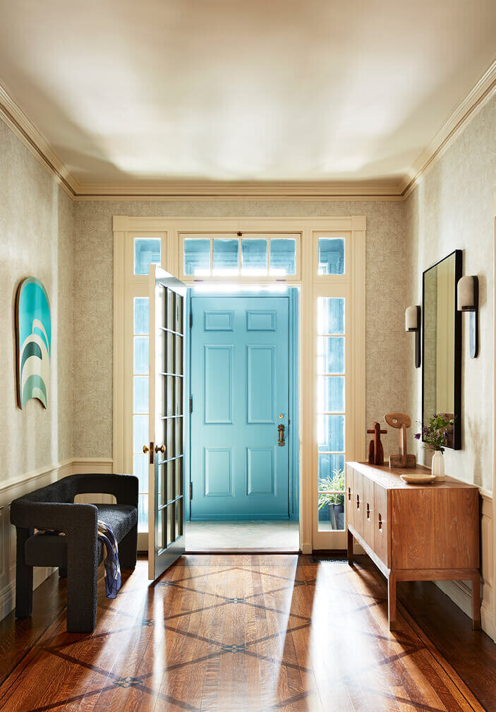  Interior design Boston transforms this historic home foyer with a bold blue entryway and modern furniture, blending classic charm with fresh design.