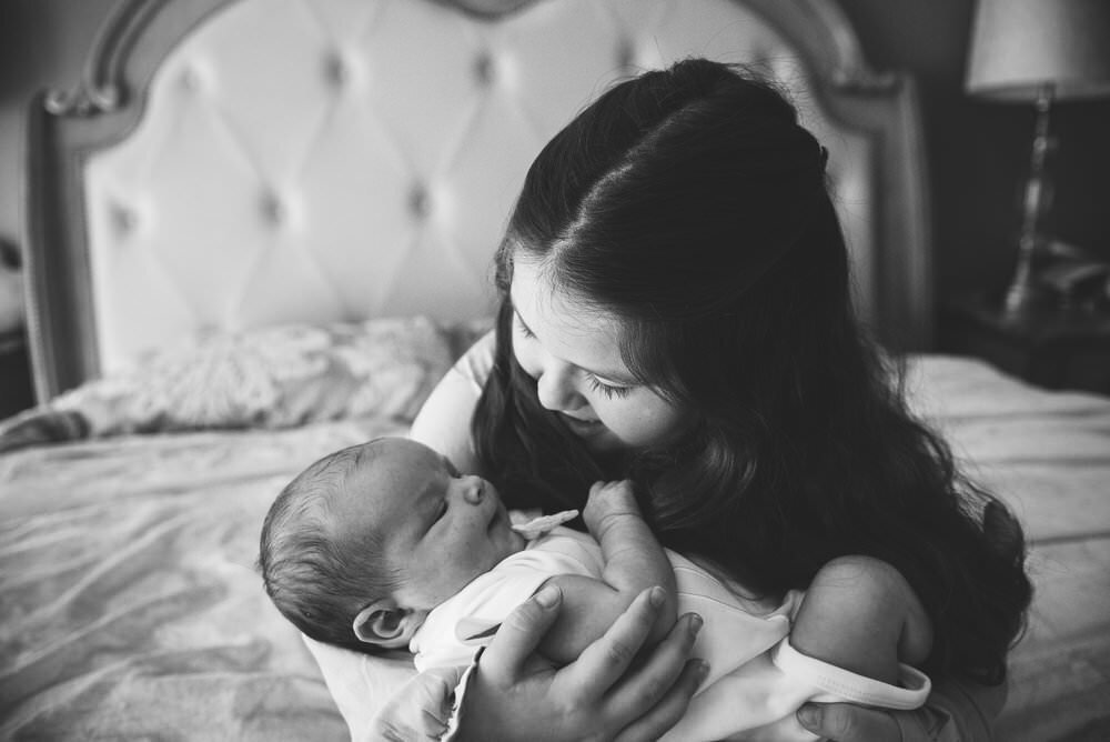 sister holding baby brother in -home  Navarre