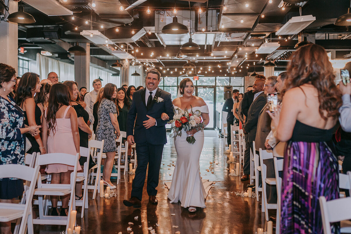 Mom and dad of the wedding couple walking in the aisle