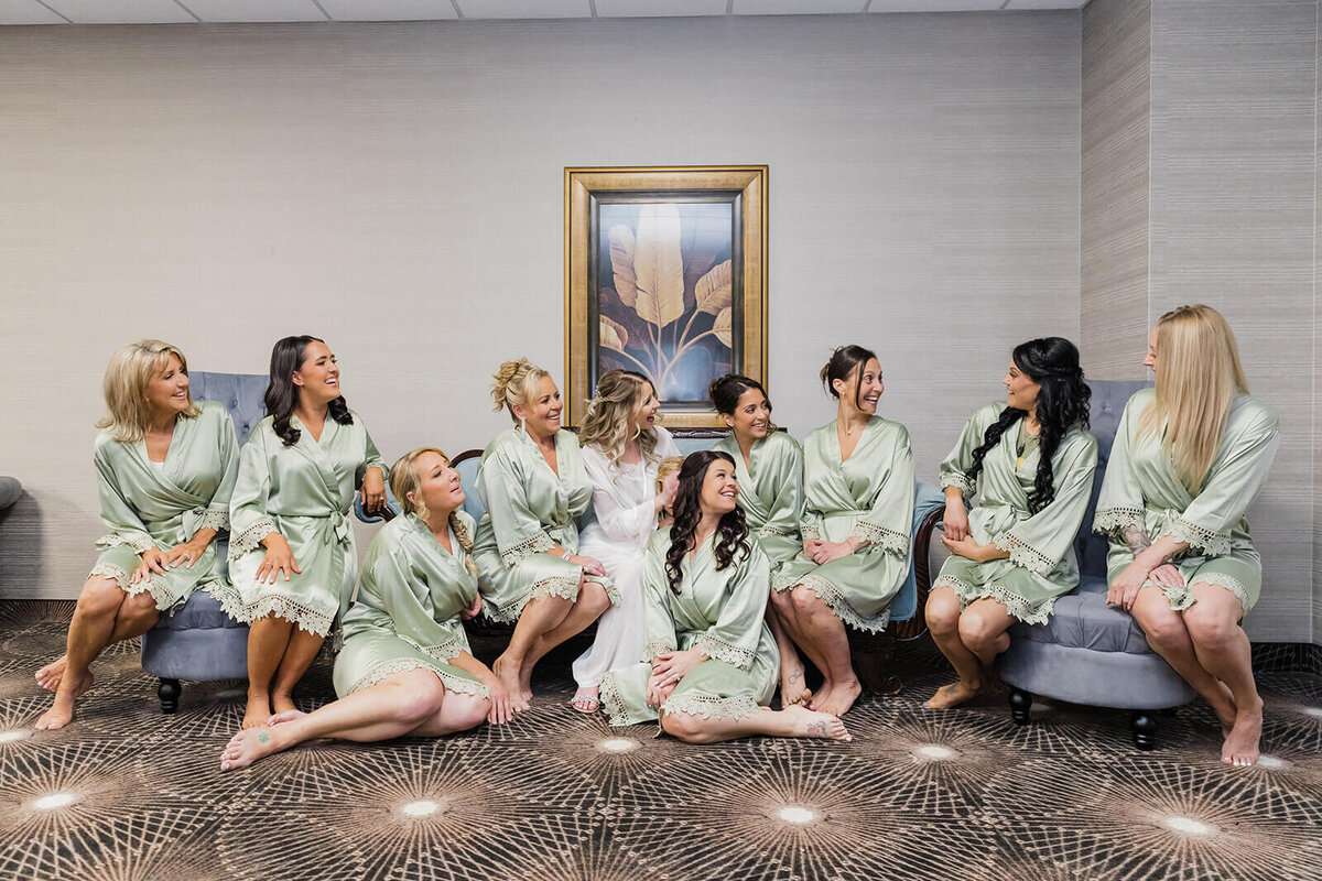Bride with bridal party wearing pale green robes
