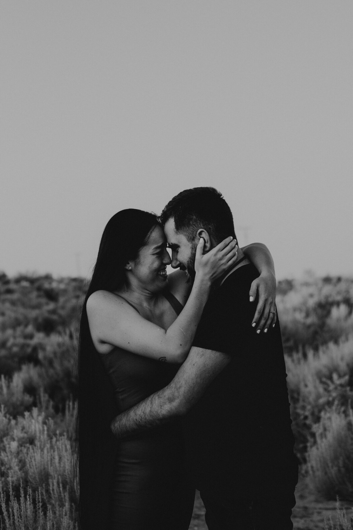 engaged couple holding each other in Albuquerque