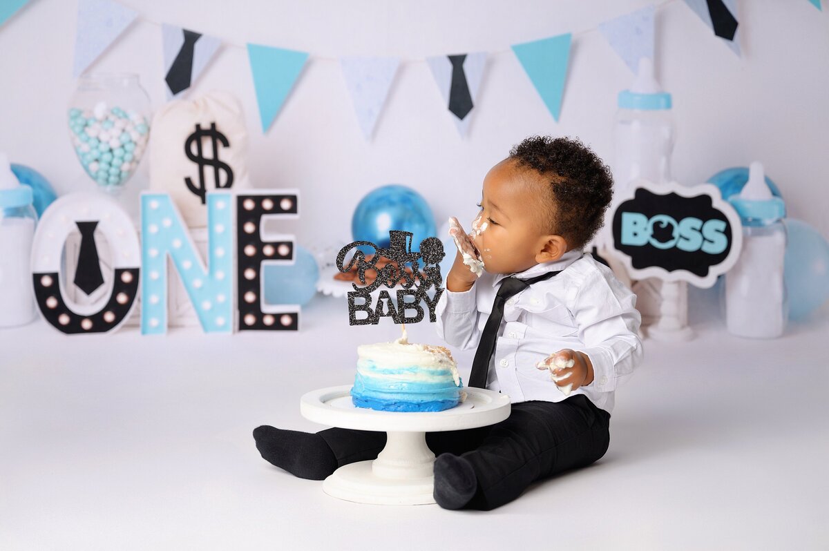 Baby boy celebrates first birthday with a boss baby themed cake smash photoshoot in Miami, FL.