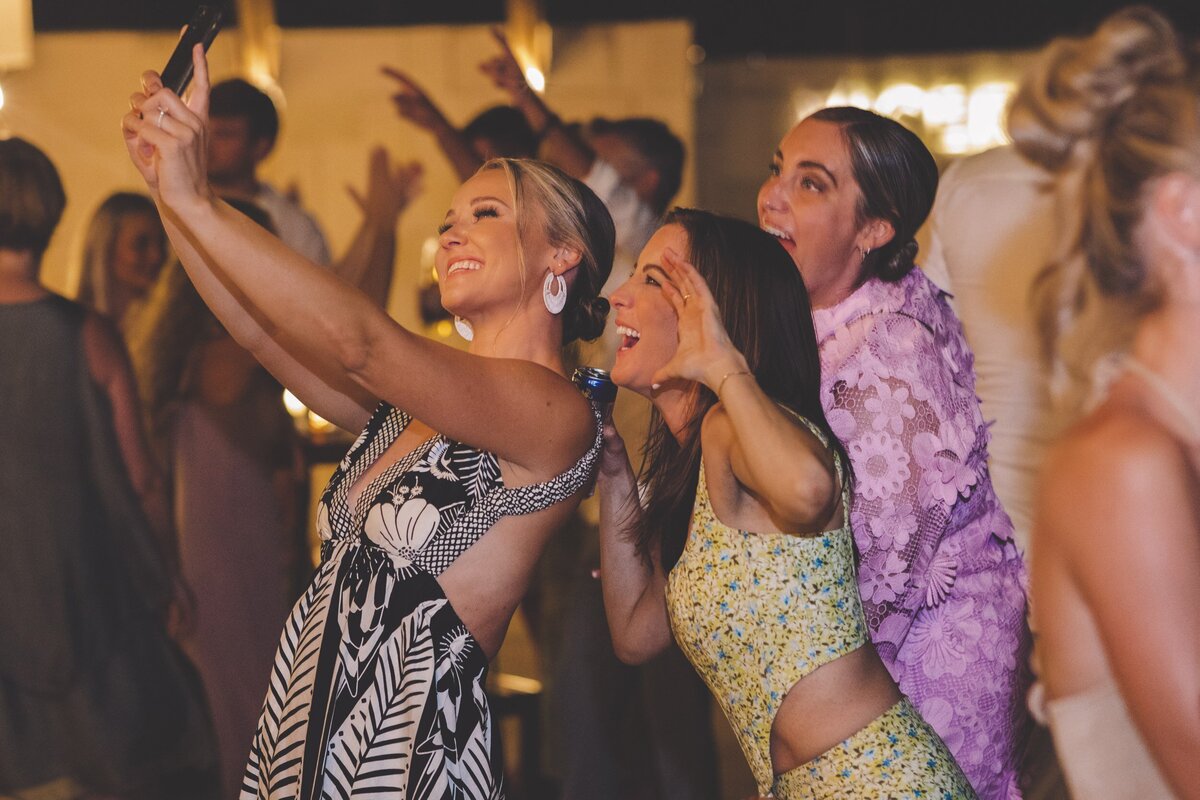 Guests taking selfie at wedding in Riviera Maya
