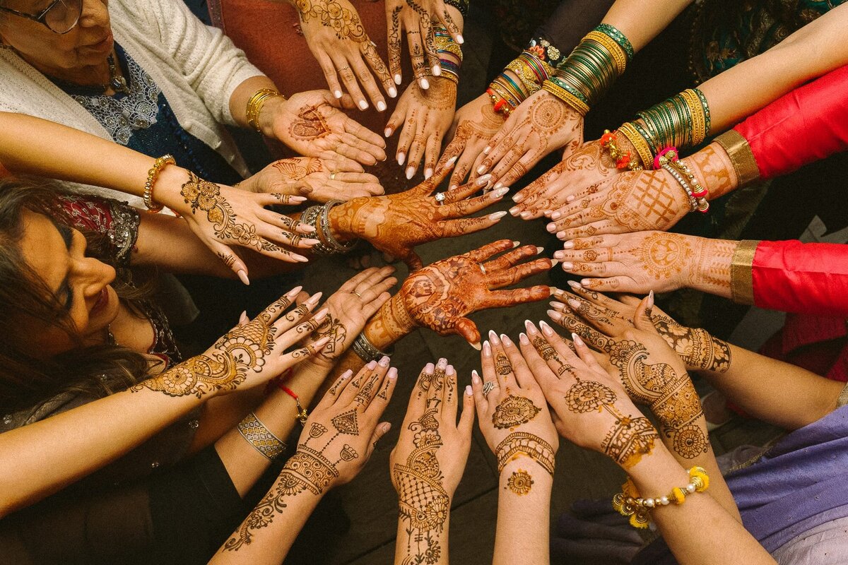 all the ladies showing off their henna at a mehndi