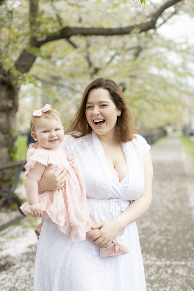 portrait of toddler girl with mom at the park in the spring