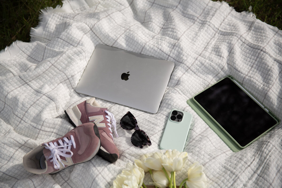 Graphic, web and branding designer Bess Brownlee gathers her laptop, phone and iPad outside in Missoula, Montana.