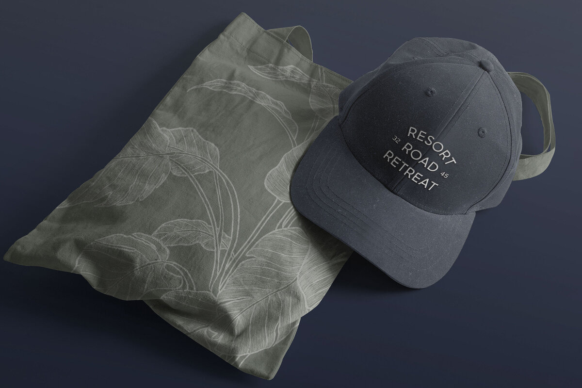 Logo design shown on merchandise. Hat and graphic pattern bag