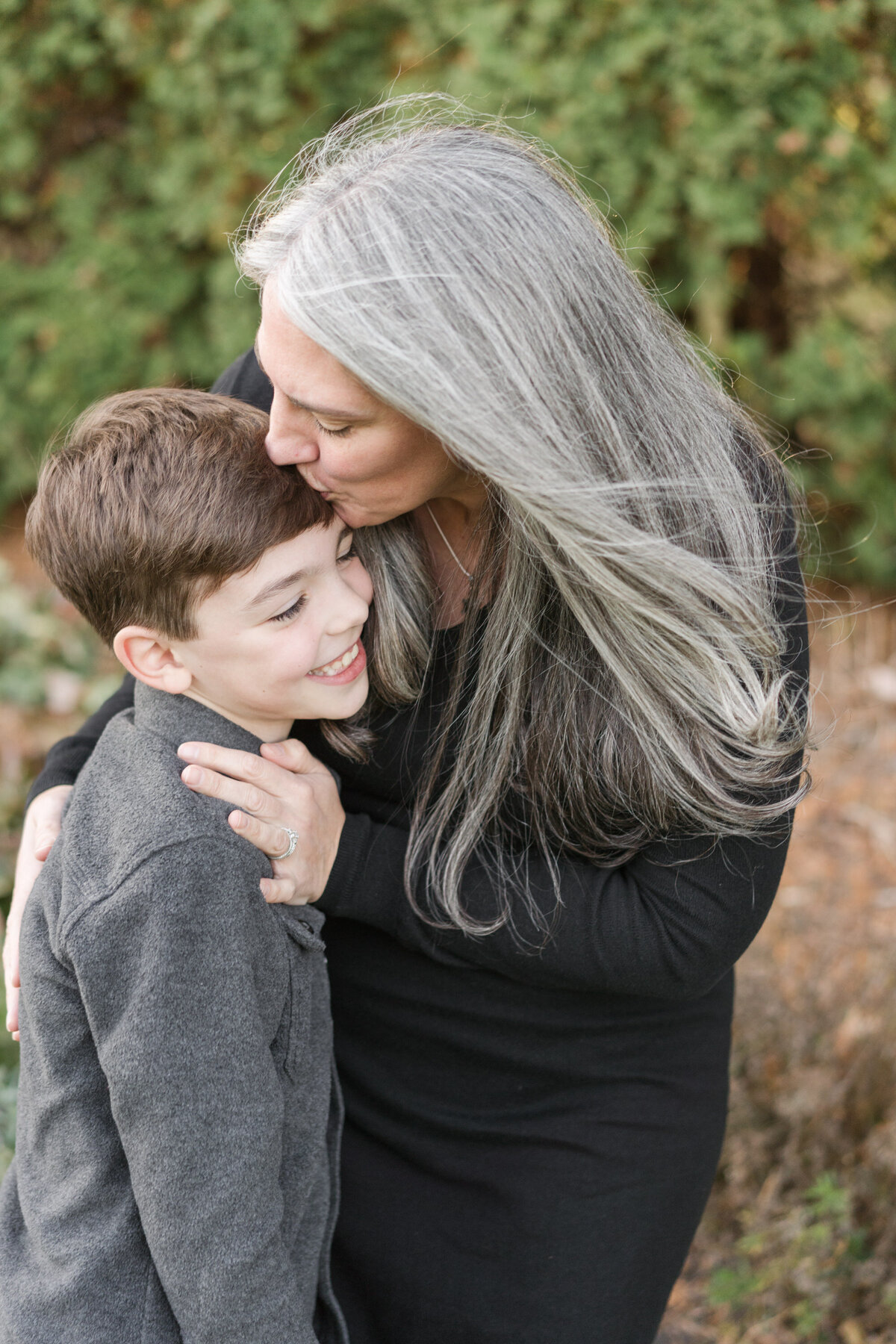a mother with her older son in a sweet embrace during a Minneapolis Portrait Session by Yantes Photo