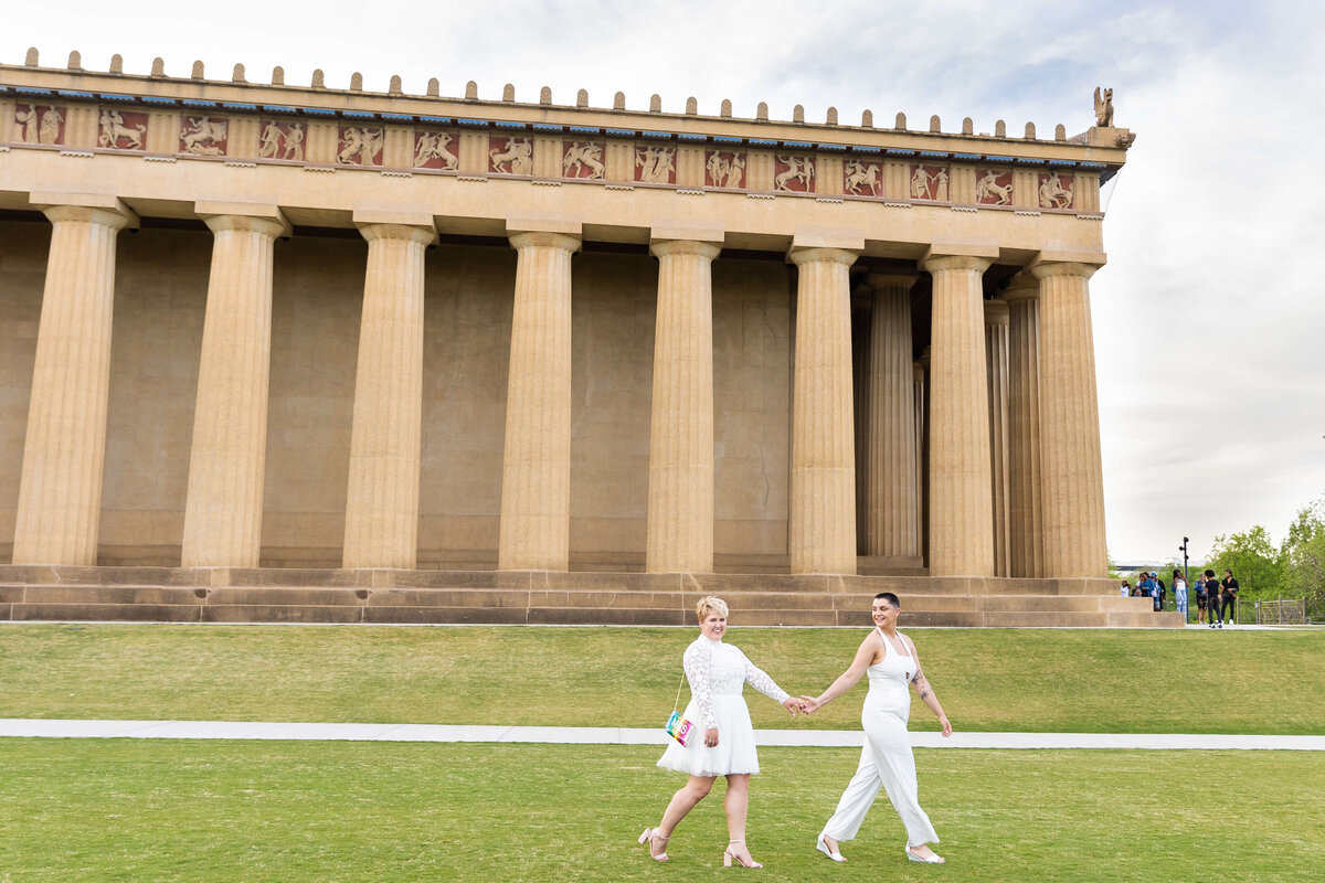Gay women holding hands at LGTBQ wedding in Centennial Park, Nashville,TN
