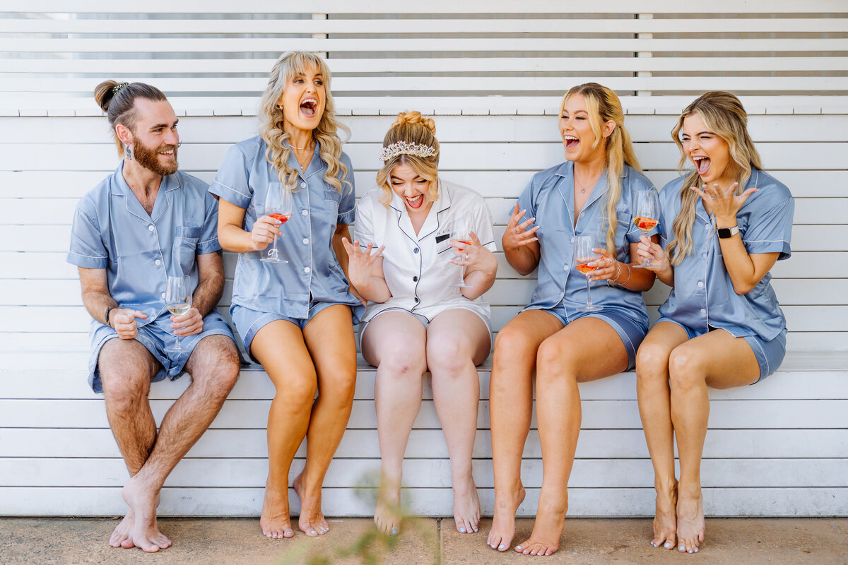 Bride sitting with her brides maid screaming in excitement