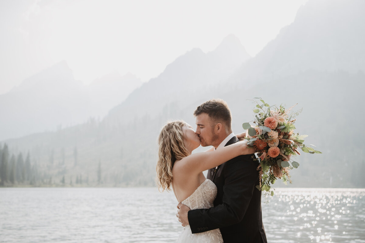 Jackson Hole Photographers capture bride and groom kissing