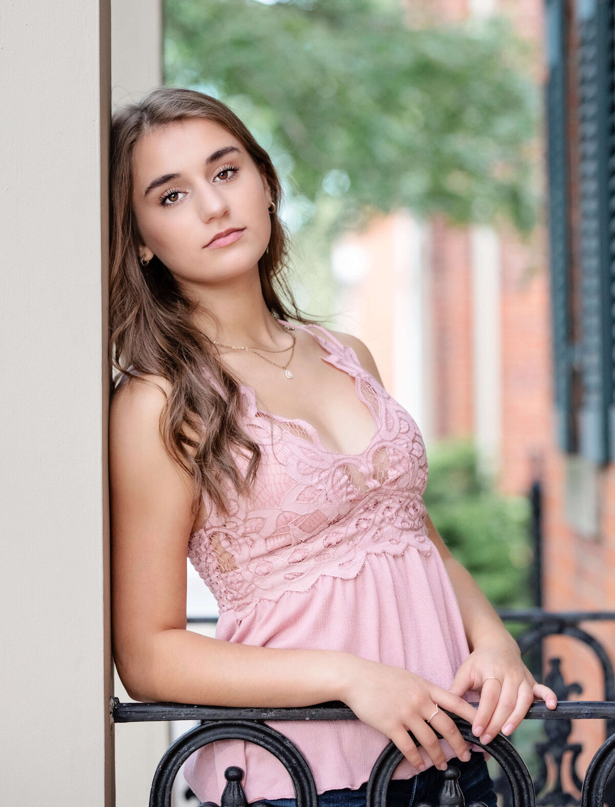 Senior photo of a girl on a porch in downtown Erie Pa