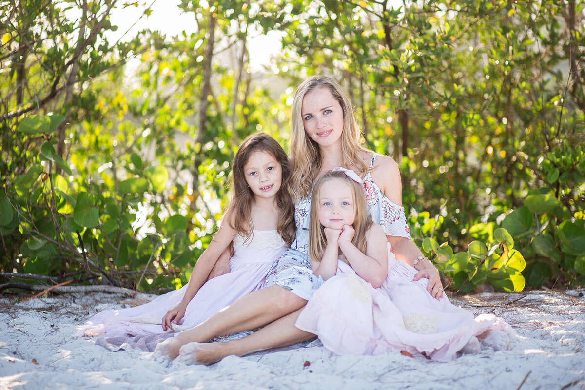Blonde mother posed with her two daughter on the beach in early morning. Located at Siesta Key, Sarasota, FL 
