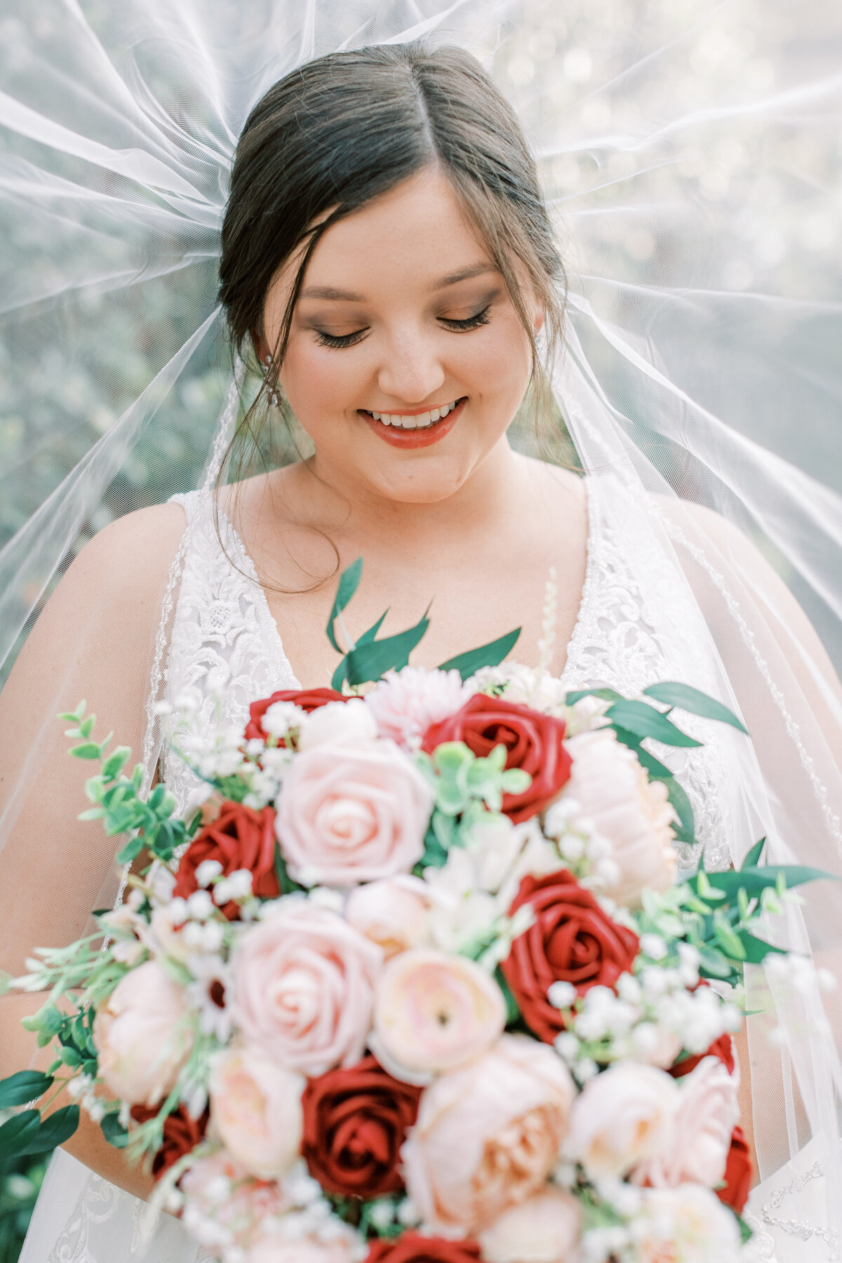 A bride holds her bouquet up close.