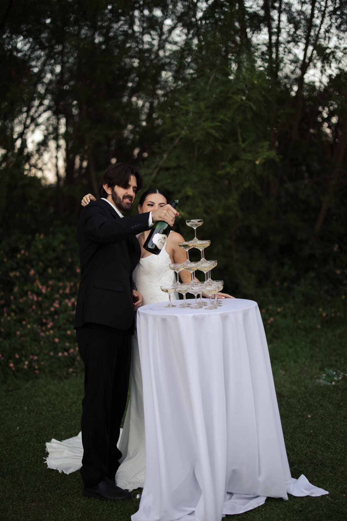 Bride and groom pouring champagne