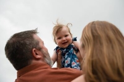 Happy toddler laughing during indoor family photo session with St Augustine family photographers capturing precious moments