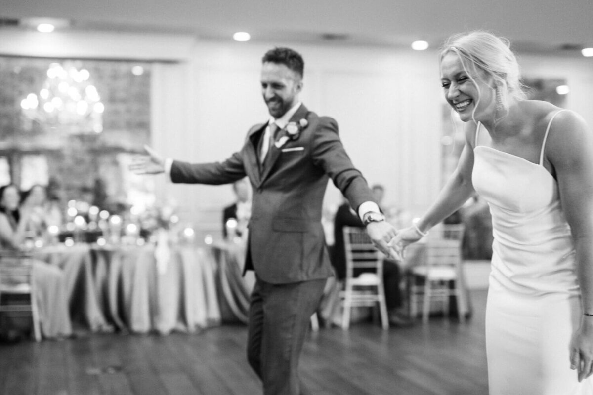 couple-laughing-while-bowing-to-guests-after-dance