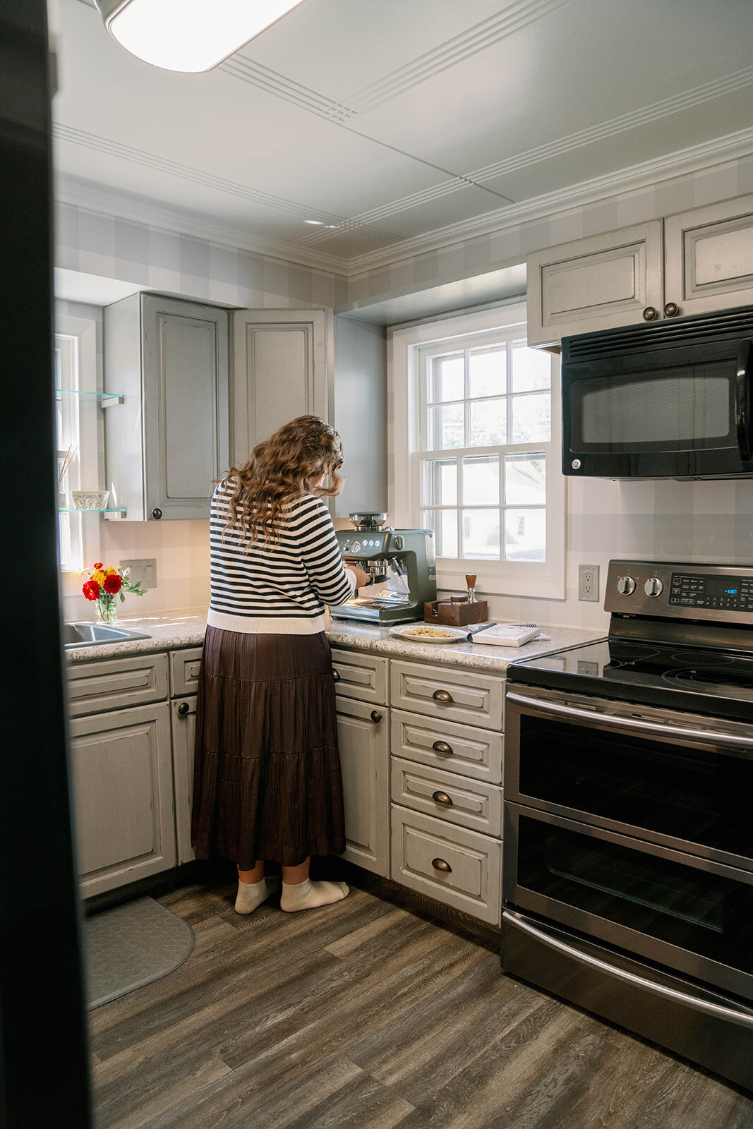 Woman standing at a kitchen counter preparing food during the planner company branding session in Indiana.