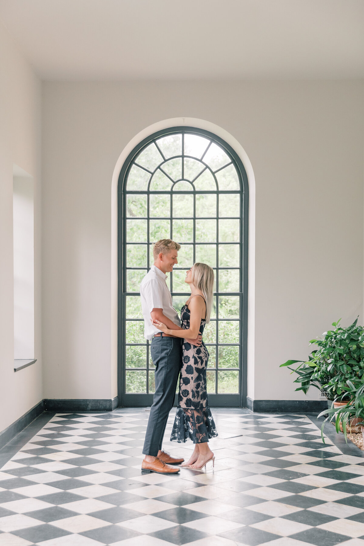 Couple in light hallway with black and white tiled floor at Conestoga House