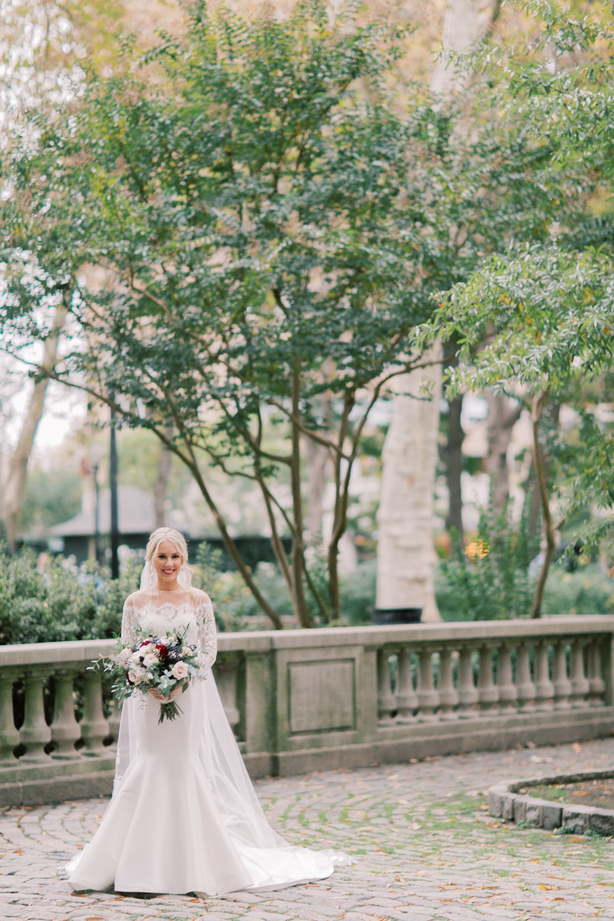 bride holding bouquet wearing long veil