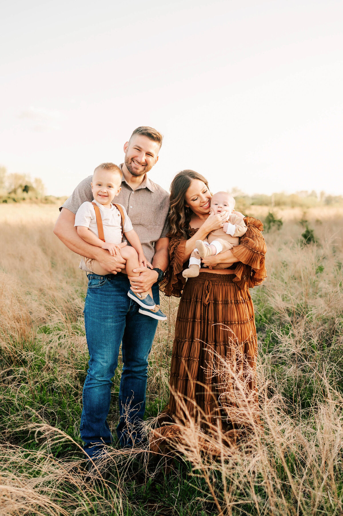 Branson MO family pictures of  cuddling in a field at sunset