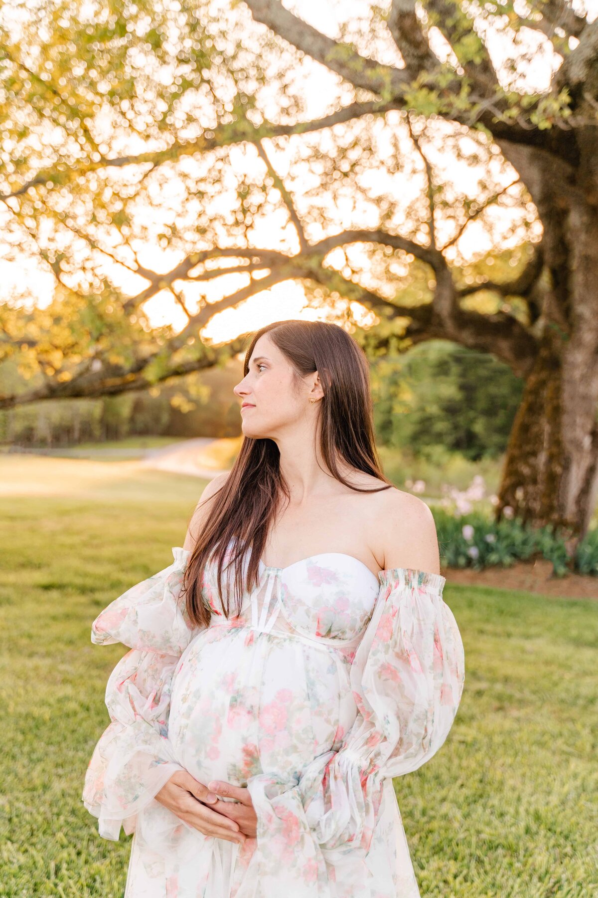 Expectant mother wearing flower glam gown at sunset