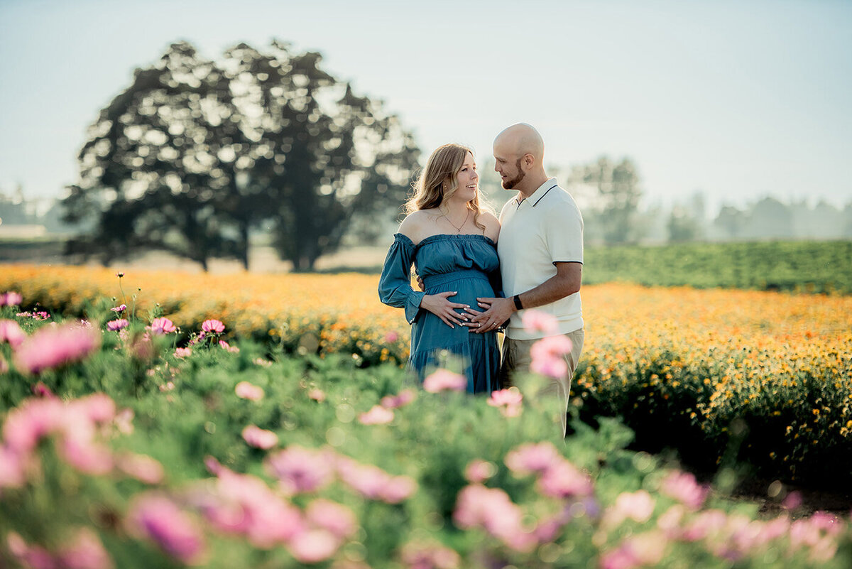 pregnant couple in flowers