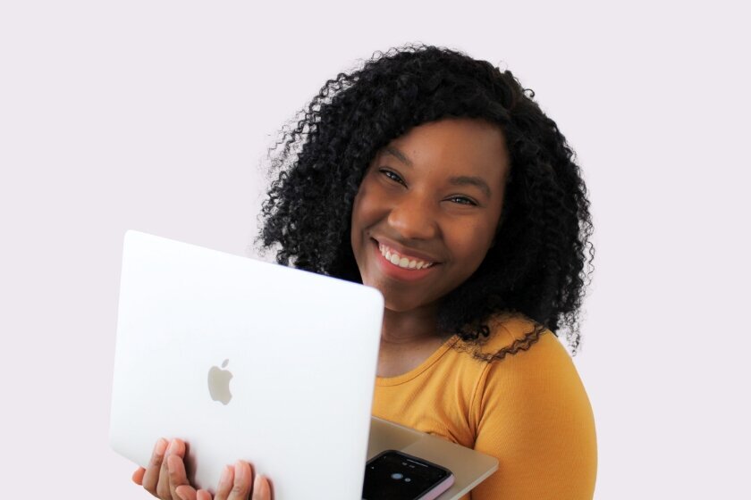 Kahja holding laptop and smiling