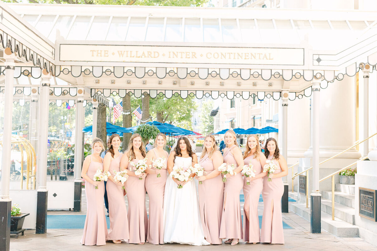 Bride with her bridesmaids holding a bouquet
