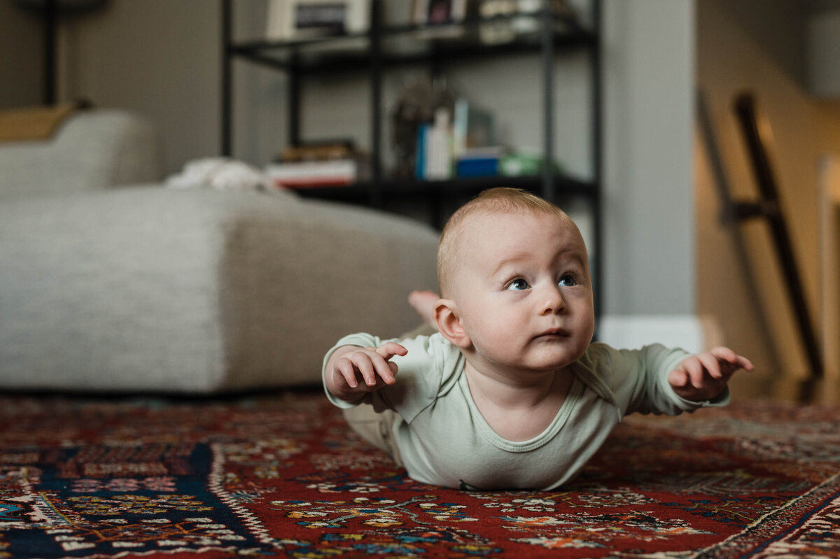 Baby having tummy time during family portrait photography session.